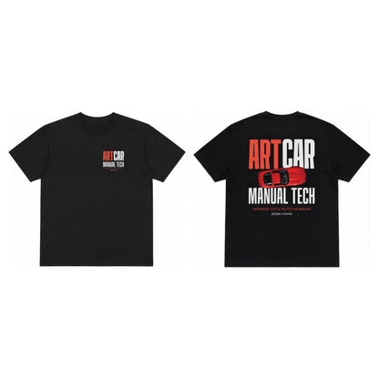 The KCAM Art Car tee in black shown front and back, with a 3.5 inch ARTCAR MANUAL TECH print on the left chest and a 12 inch back print of the same lockup with a red art car above Kansas City Auto Museum, 2026 KCMO