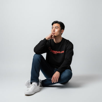 A model seated wearing the black 1991 Honda CRX Turbo crewneck with the coral Pendulum Motorsports wordmark on the chest