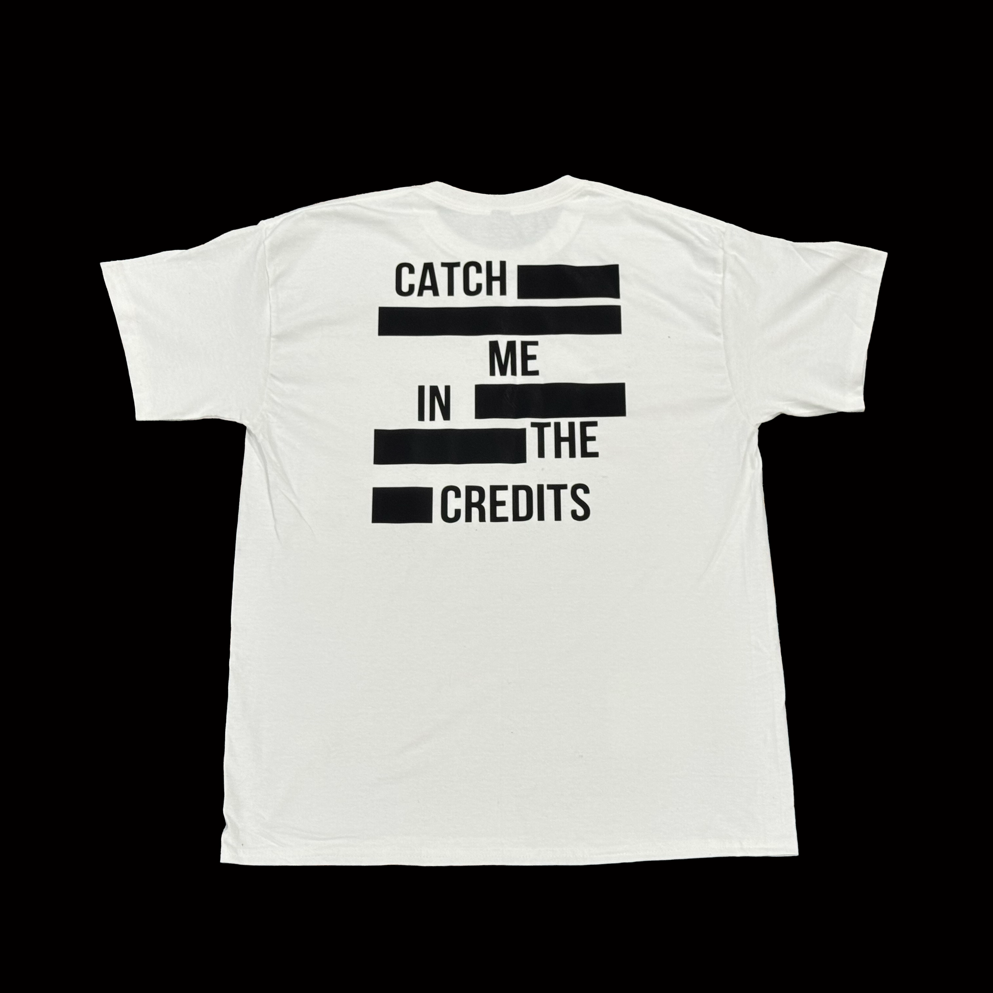 White t-shirt with black text 'Catch Me In The Credits' on a white background
