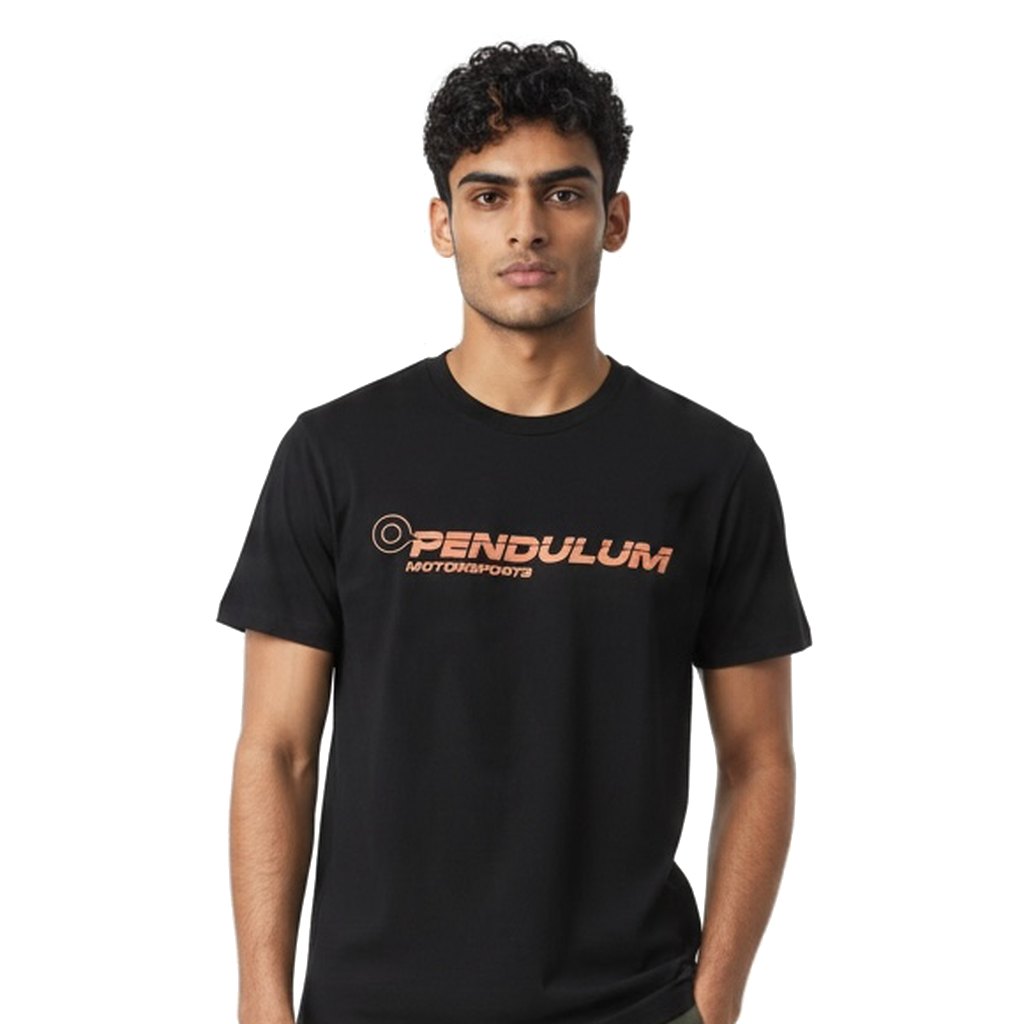Model wearing the black Pendulum Motorsports tee, front view showing the orange wordmark on the chest