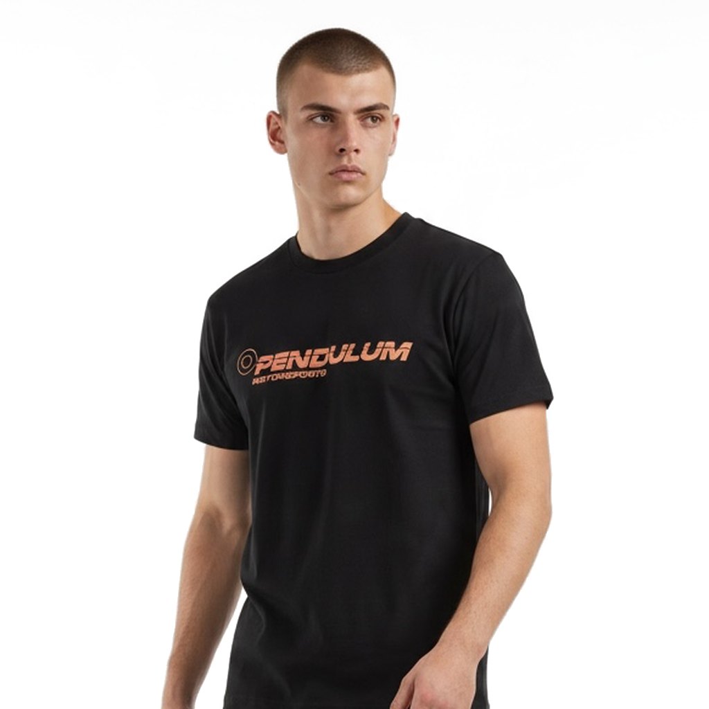 Model wearing the black Pendulum Motorsports tee, relaxed front view showing the orange wordmark on the chest